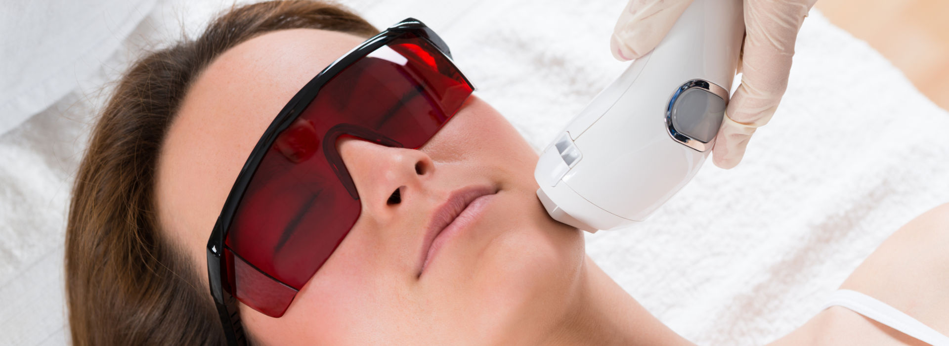 A woman is getting a laser treatment.