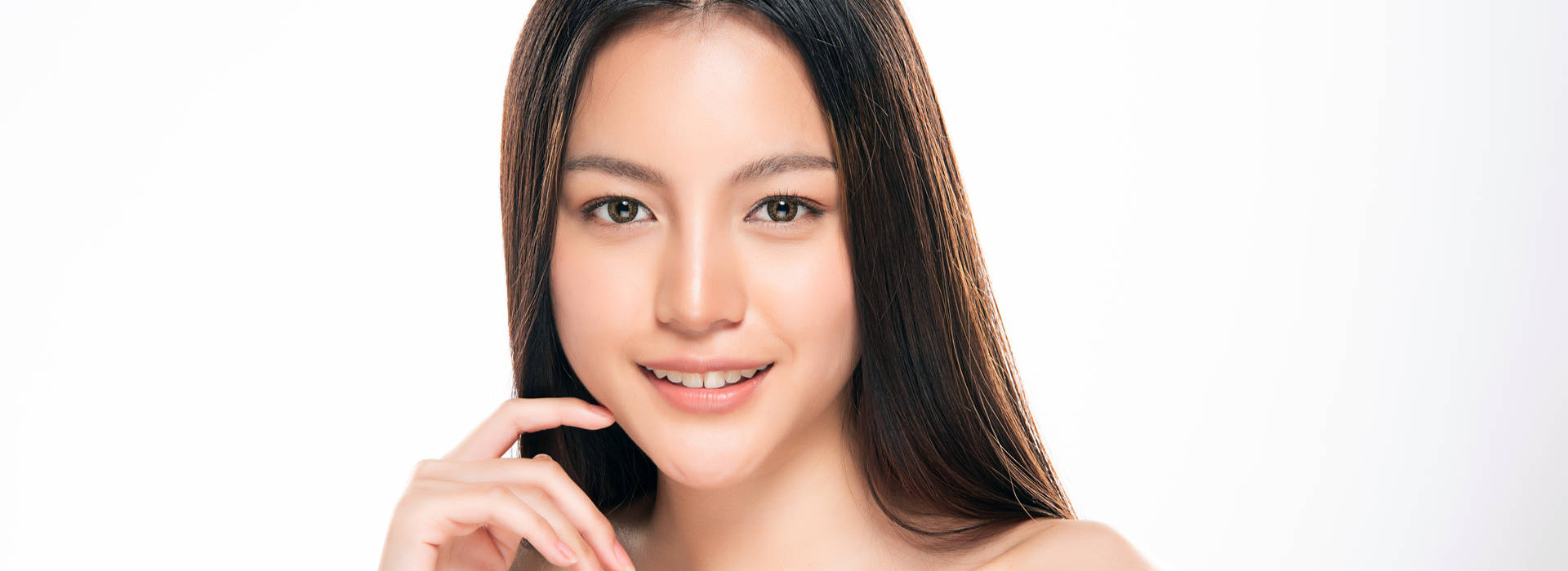 A beautiful woman is smiling after medical grade skin care.